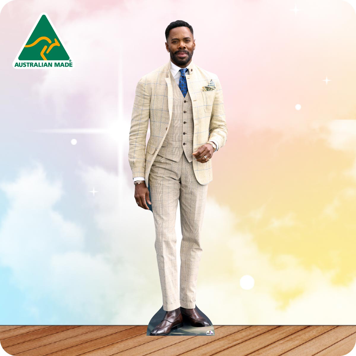 Cardboard cutout of a man in a cream colored suit with 'Australian Made' logo on a colorful background