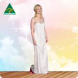 Woman in a white evening gown standing on a wooden floor with a colorful background, Australian Made logo visible.