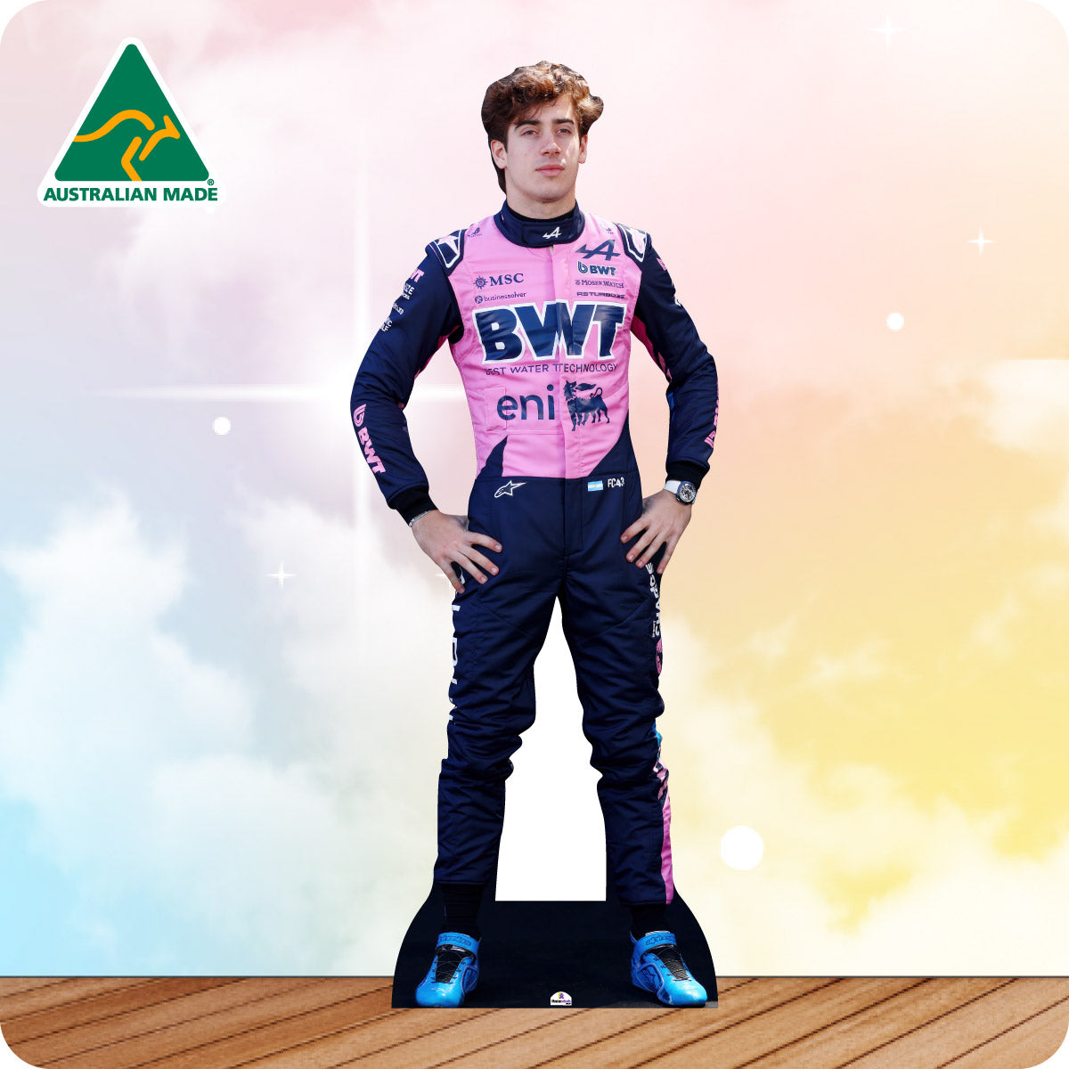 Cardboard cutout of a person in a racing suit with sponsor logos on a gradient background.