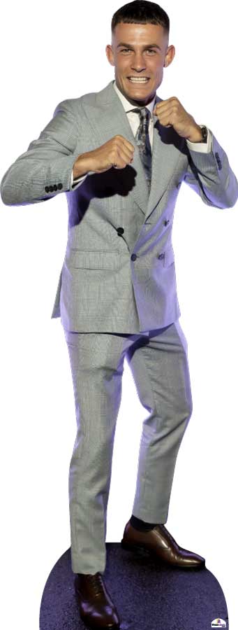 Man in a gray suit with a black shirt and brown shoes on a white background