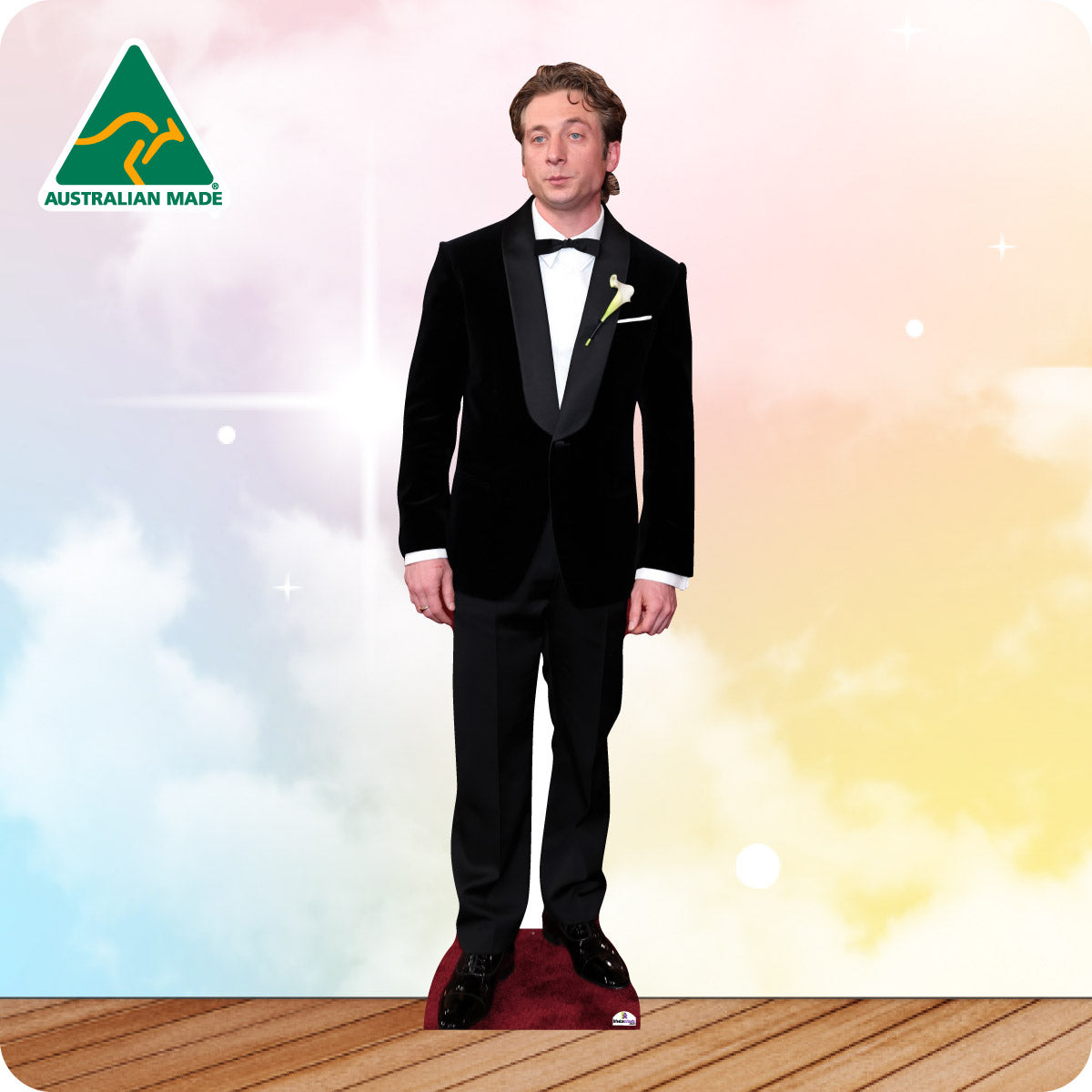 Man in a black suit standing on a wooden platform with a colorful background and Australian Made logo.