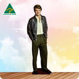 Man wearing a leather jacket and green pants standing on a wooden floor with a colorful background and 'Australian Made' logo.
