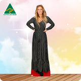 Woman wearing a long black and gold striped dress with 'Australian Made' logo in the corner.