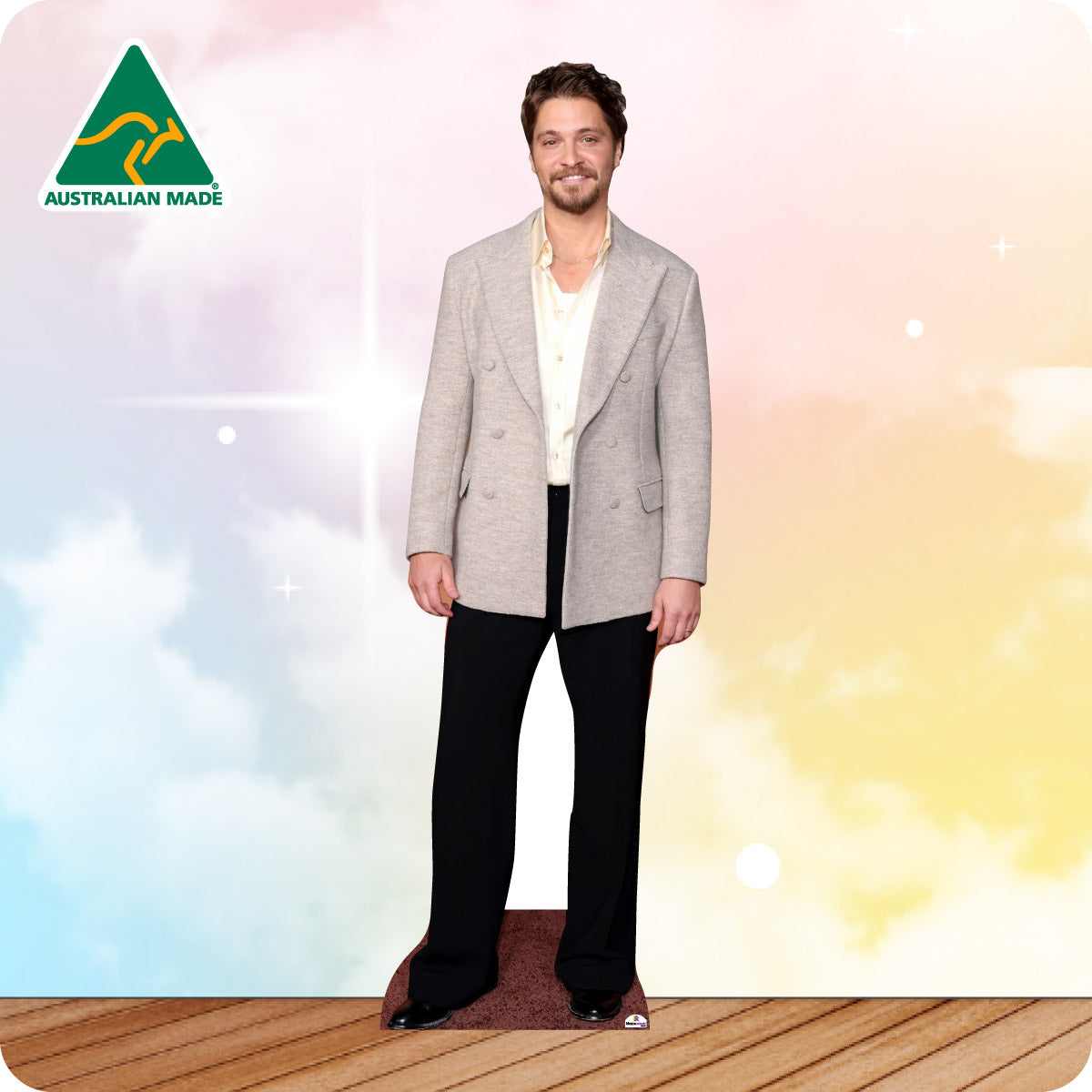 Cardboard cutout of a person in a grey jacket with 'Australian Made' logo on a colorful background
