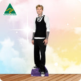Cardboard cutout of a person wearing a black vest and pants with a white shirt, standing on a wooden floor with a colorful gradient background.