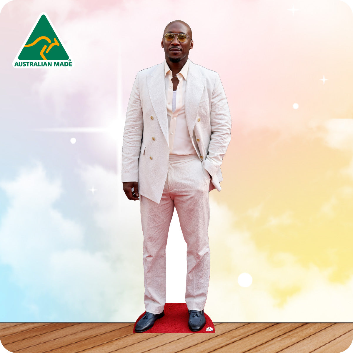 Man in a white suit standing on a red platform with a colorful background and Australian Made logo.