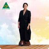 Woman in a black suit standing on a wooden floor with a colorful gradient background and Australian Made logo.