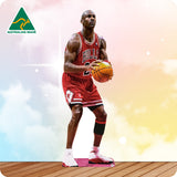 Basketball player in a red jersey holding a basketball on a wooden floor with a colorful background and Australian Made logo.