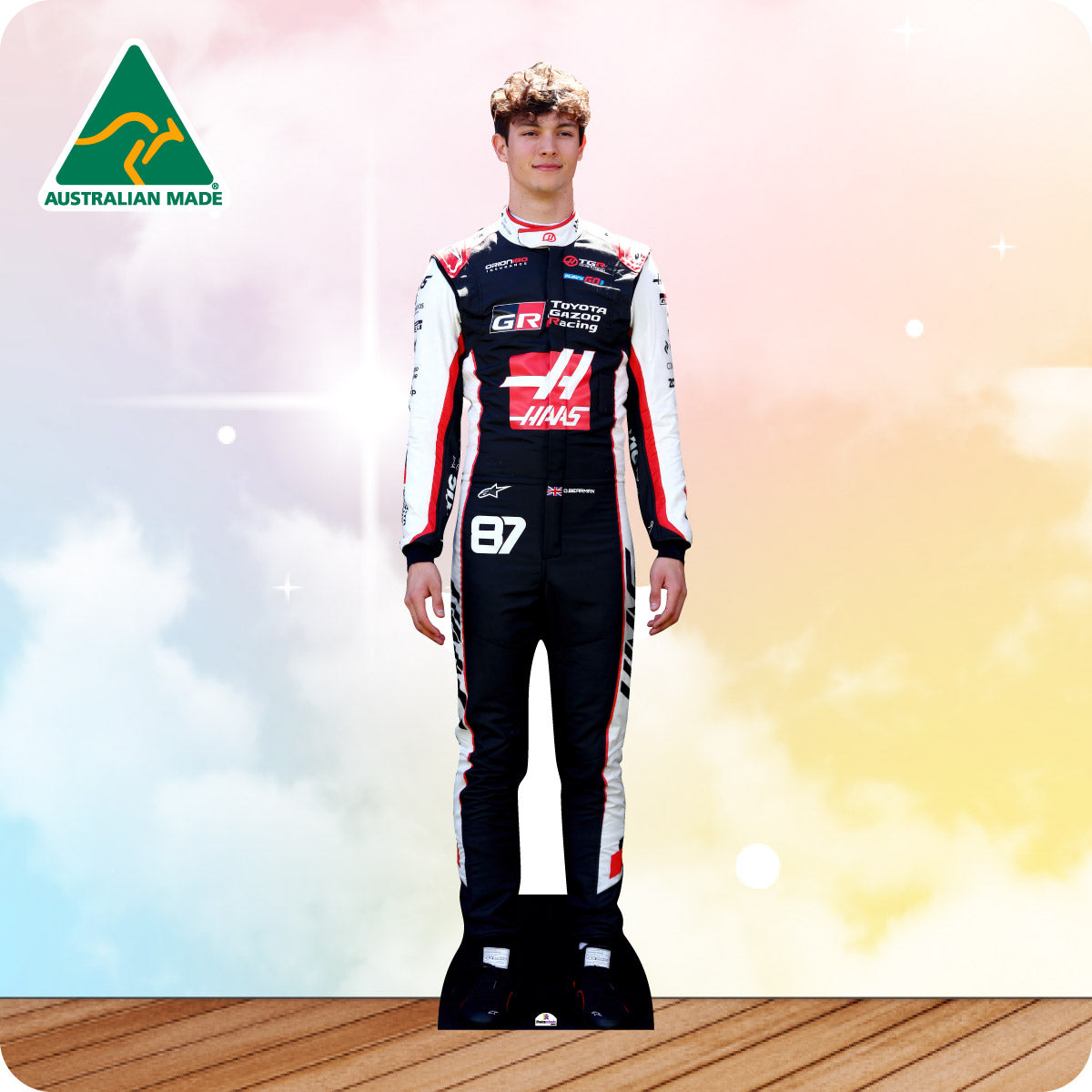 Person wearing a racing suit with visible branding against a gradient background