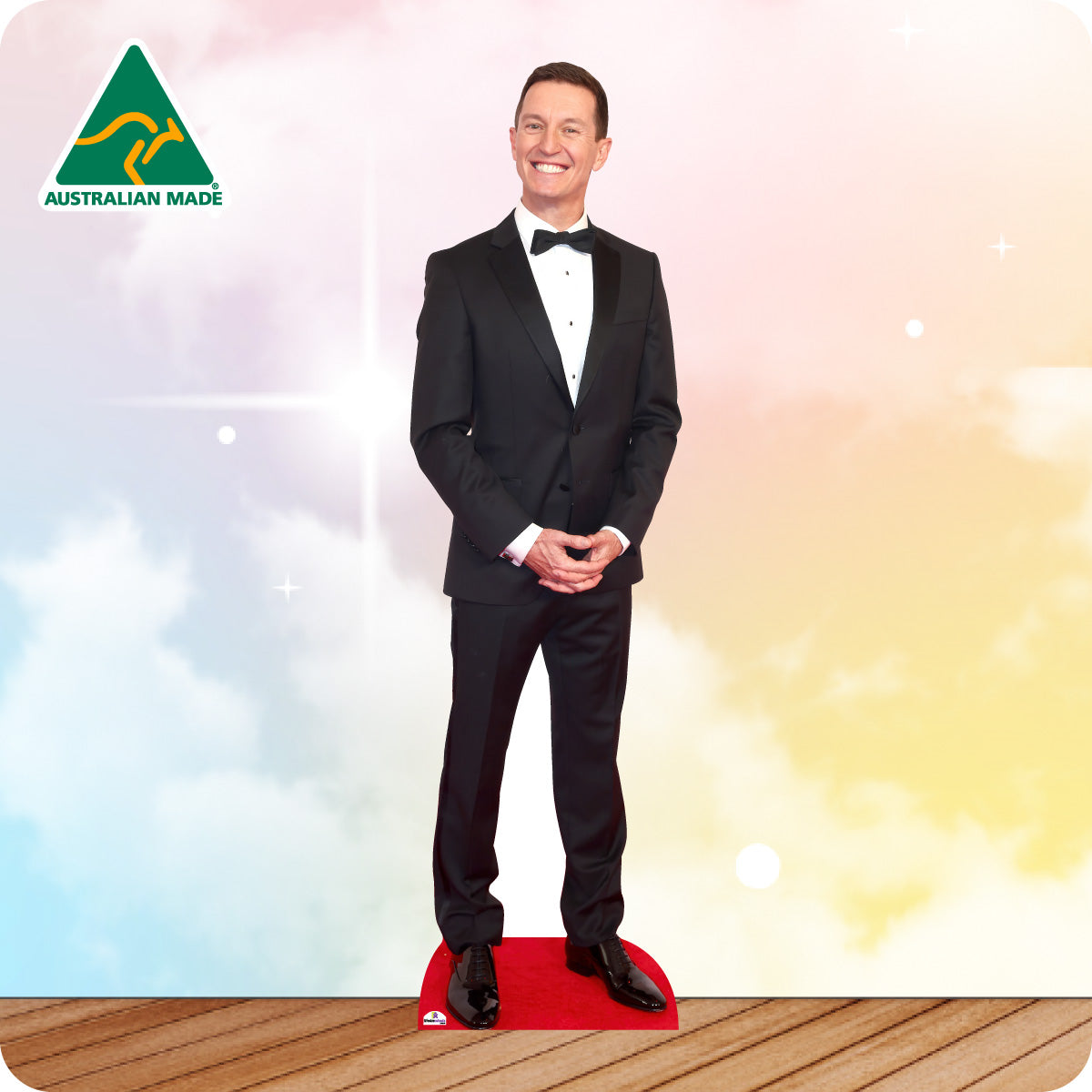 Cardboard standee of a man in a black tuxedo on a colorful background with 'Australian Made' logo.