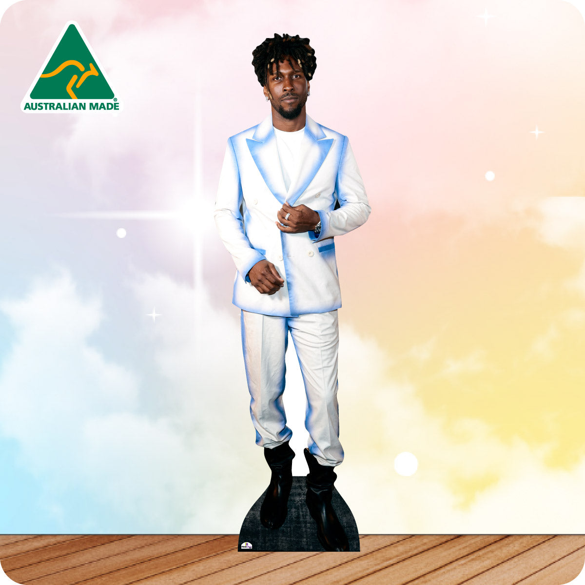 Man in a white suit with blue accents standing on a wooden floor with a colorful gradient background.