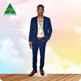 Man in a blue suit with a floral shirt on a white card stand against a colorful background with 'Australian Made' logo.