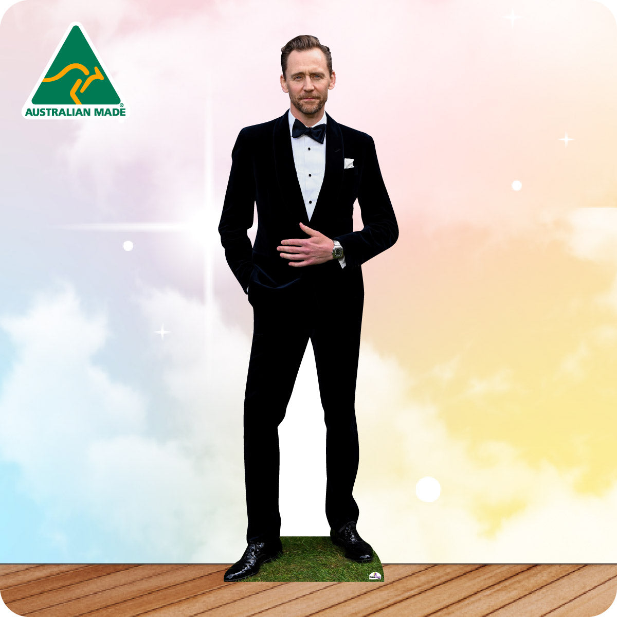 Cardboard cutout of a man in a black suit with a bow tie on a wooden floor.