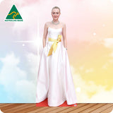 Woman in a white gown with a gold belt on a colorful background with 'Australian Made' logo.