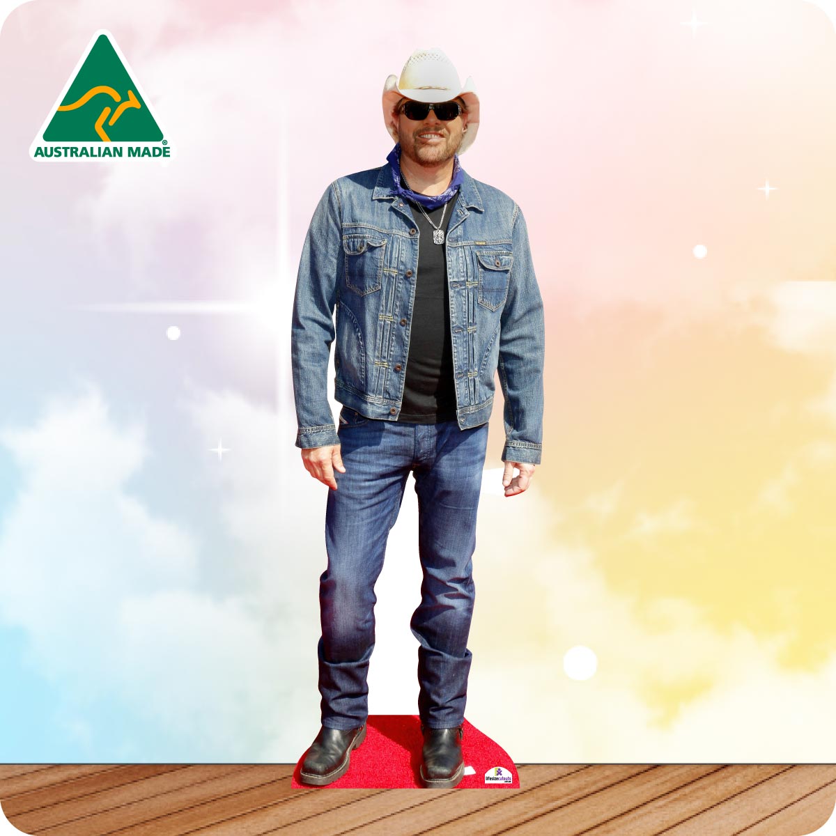 Life-size Toby Keith cutout wearing a black cowboy hat, black shirt, blue jeans and brown boots.