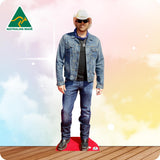 Life-size Toby Keith cutout wearing a black cowboy hat, black shirt, blue jeans and brown boots.